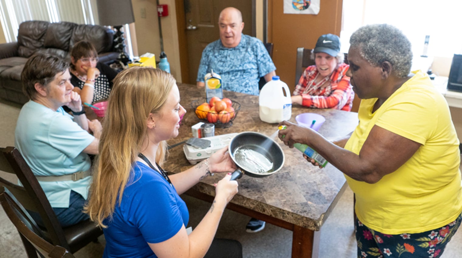 People in a community home preparing a meal together
