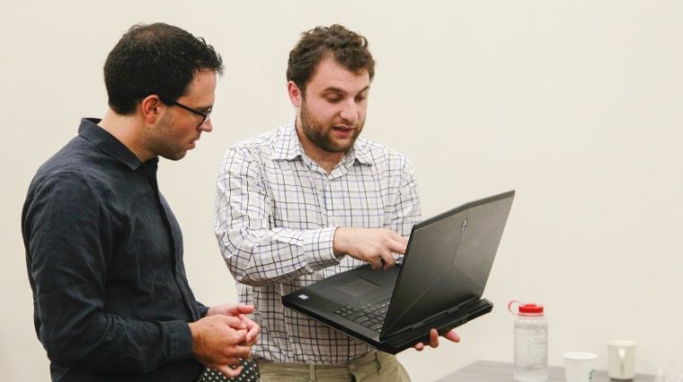 Joseph Riddle, left, director of Neurodiversity in the Workplace, works with David Chidester, 22, on a project