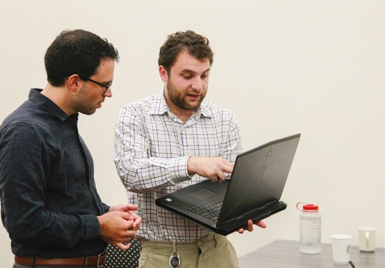 Joseph Riddle, left, director of Neurodiversity in the Workplace, works with David Chidester, 22, on a project